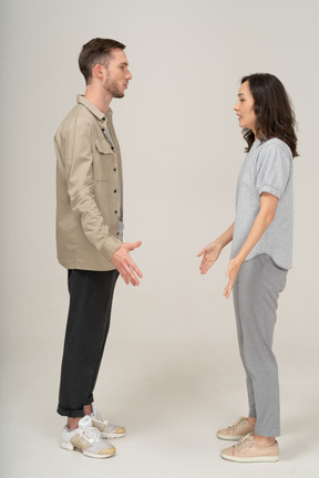 Side view of young couple speaking to each other