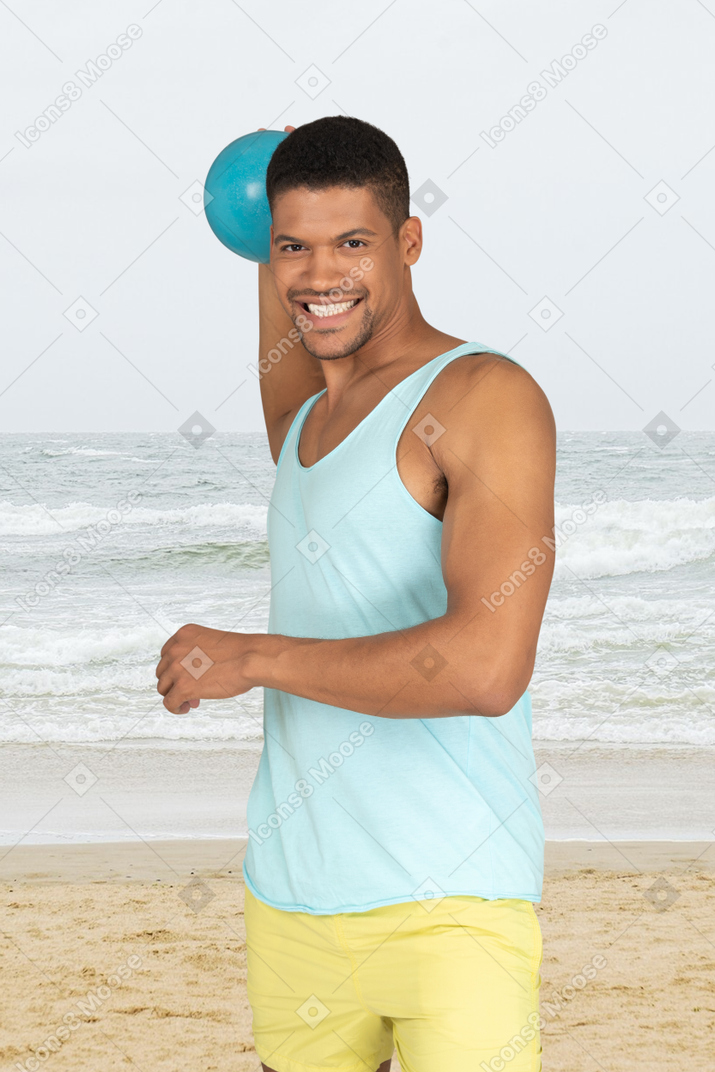 Man lifting weights at the beach