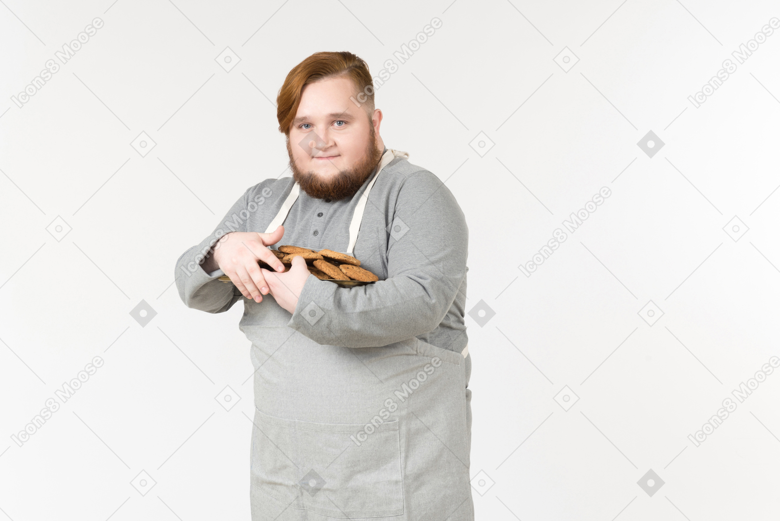 A pleased fat man holding close a plate of cookies