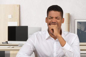 A man yawning at the office