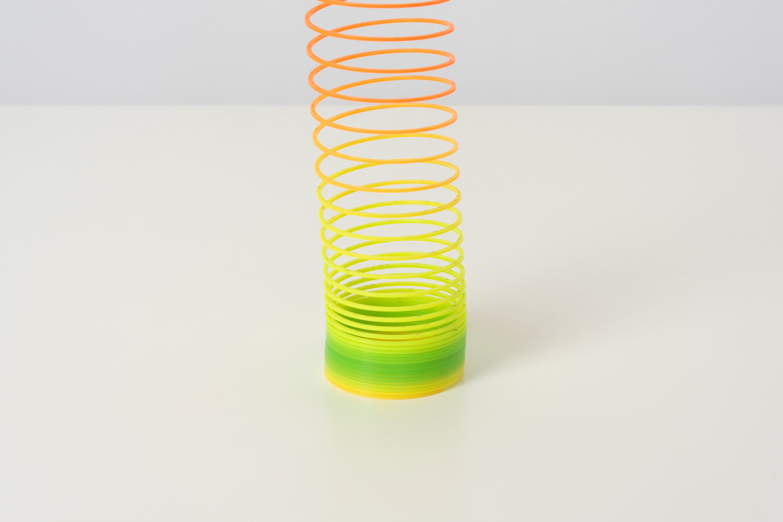 A colorful slinky toy being unbearably long