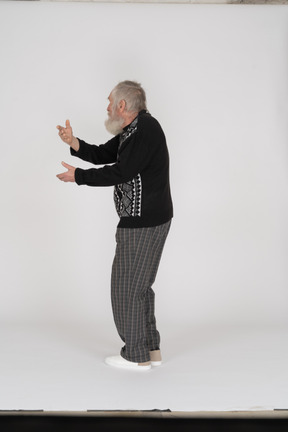 Side view of old man gesturing