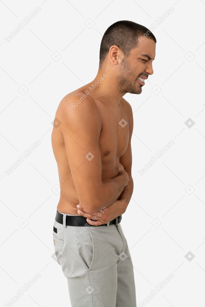 Barechested young man feels pain in stomach