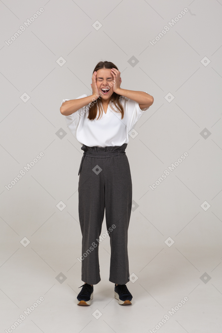 Front view of a happy young lady in office clothing touching head