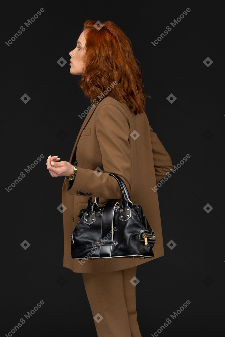 Side view of a businesswoman with handbag
