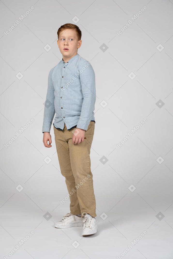 Front view of a boy in casual clothes looking aside