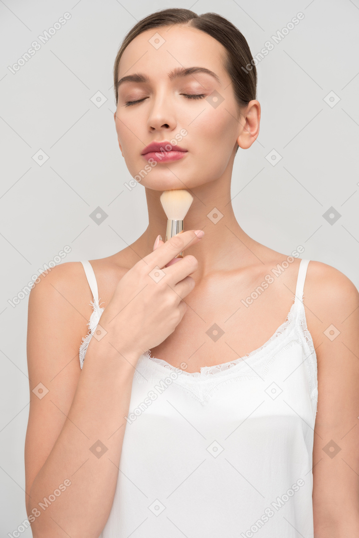 A little bit lost in thought while applying makeup