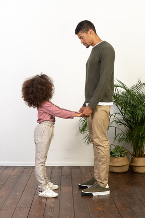 Father and daughter hold hands