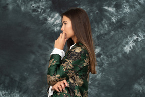 Side shot of a doubtful businesswoman in silk japanese jacket