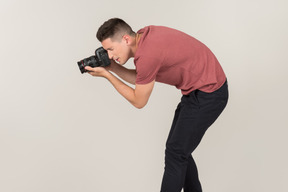 Young guy taking photos with a camera