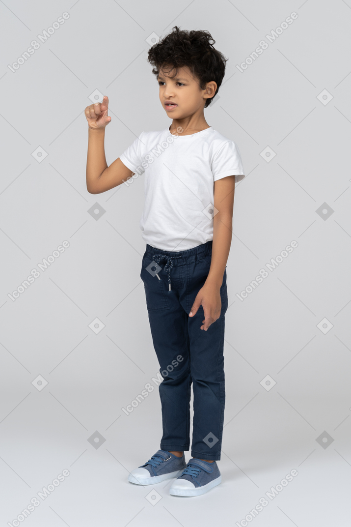 A boy showing the size of the bug he saw