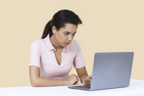 Female worker looking attintively on the computer