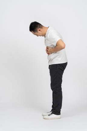 Side view of a man suffering from stomachache