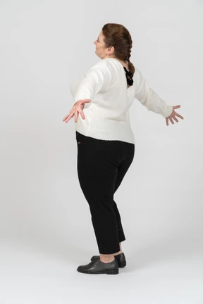 Happy plump woman in casual clothes posing