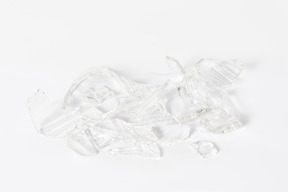 Broken glass pieces on white background