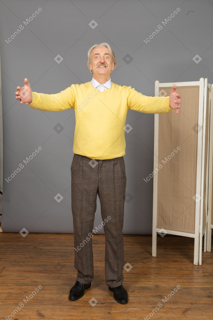 Front view of an old man outspreading his hands