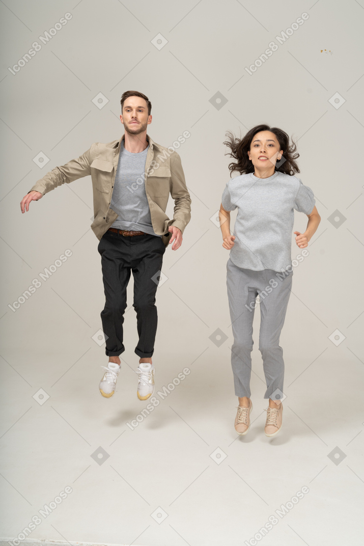 Young man and woman jumping together