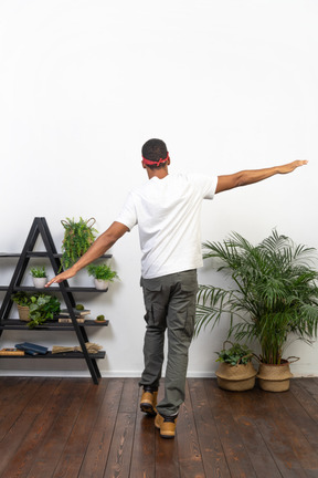 Good looking young man posing on the background of the apartment