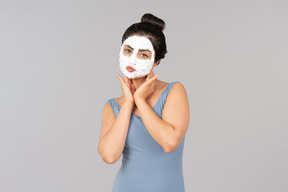 Woman with white mask on sending air kisses