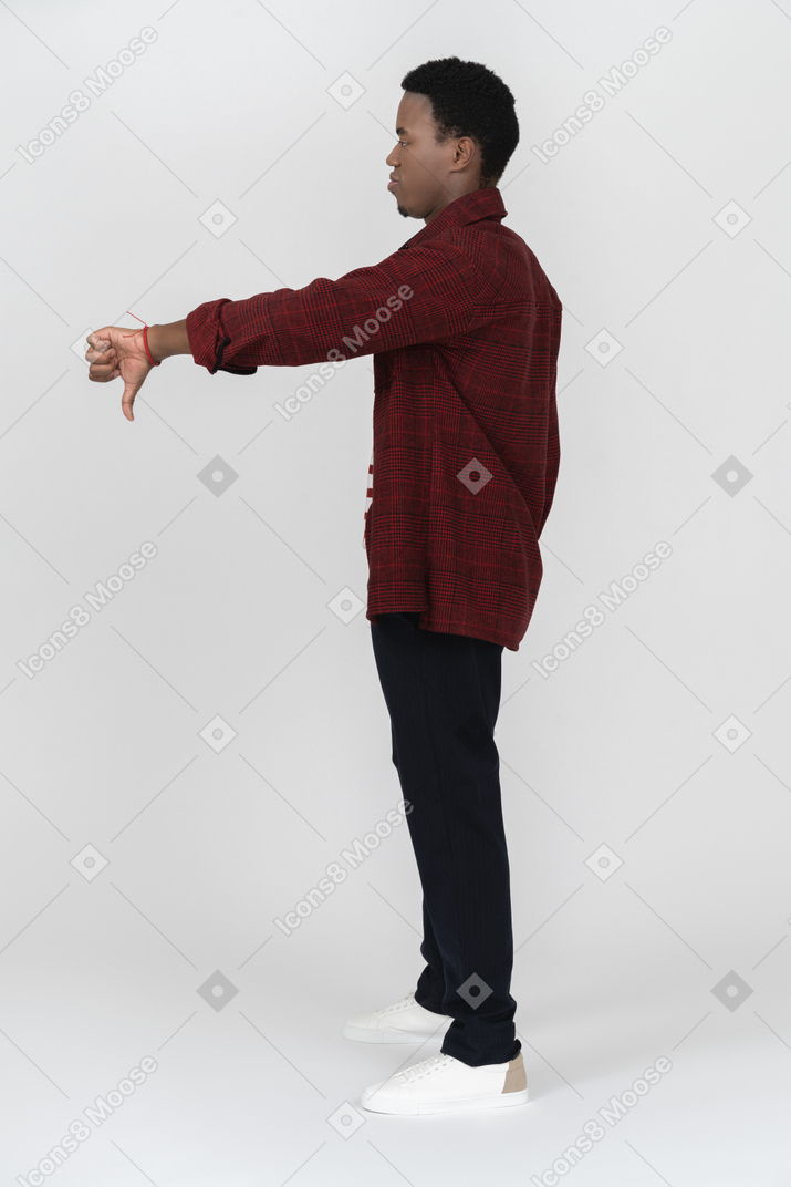 Side view of man showing dislike gesture