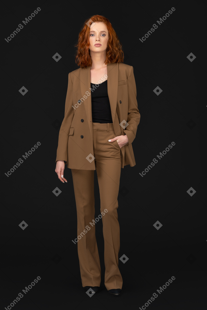 A woman in a brown suit and black top