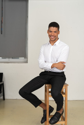 Good looking young man sitting on the chair