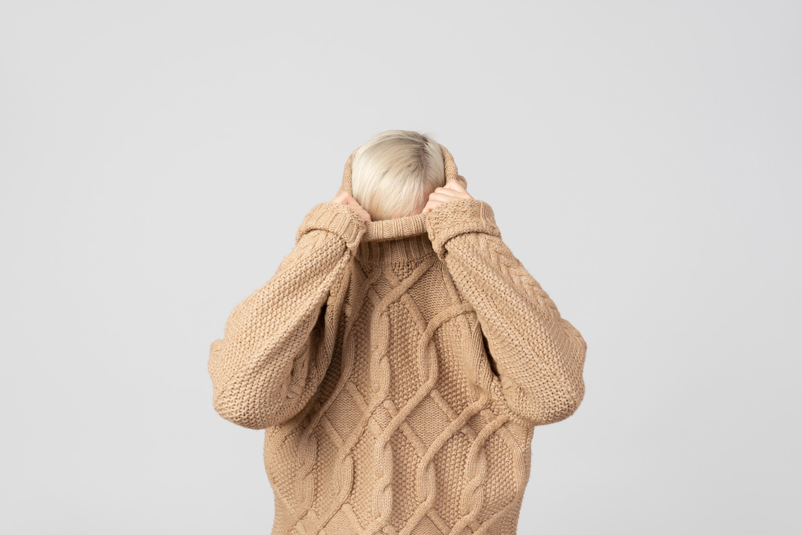 Young woman taking off her sweater