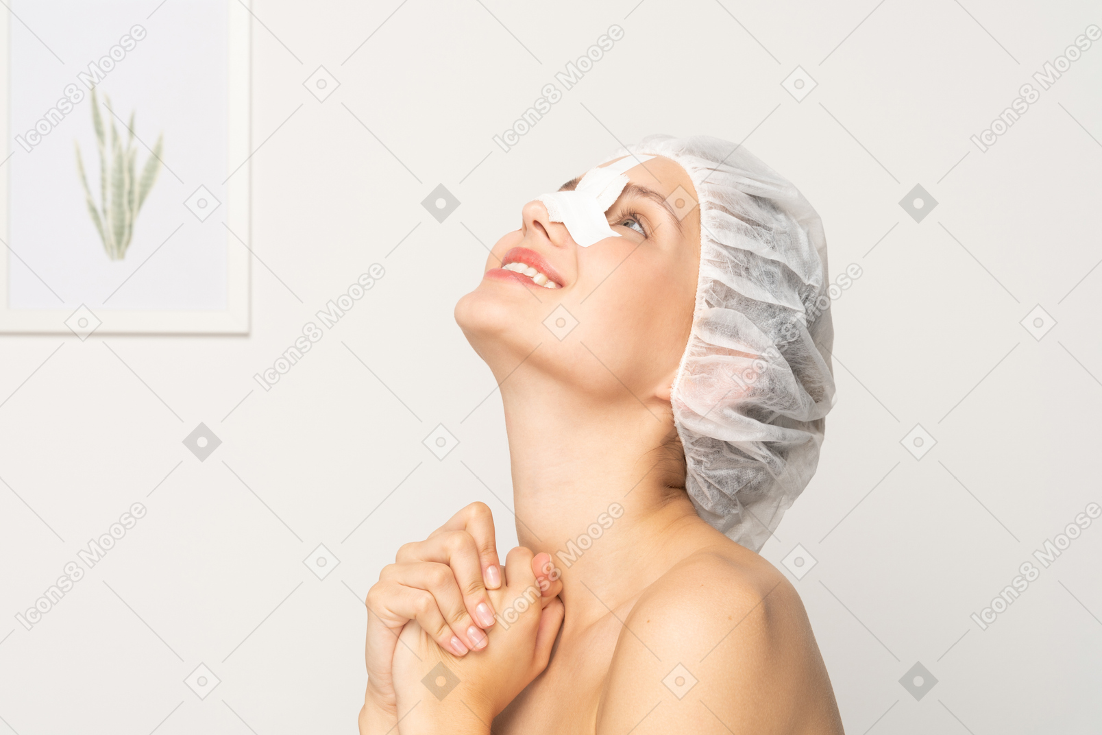 Smiling young woman with bandaged nose looking up