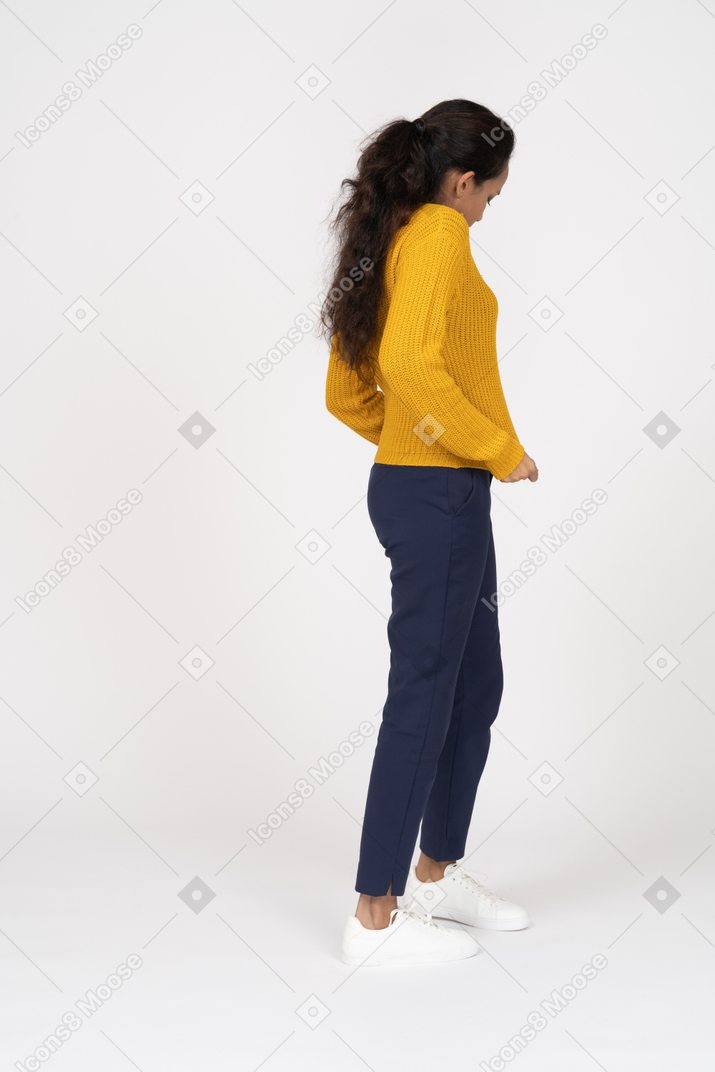 Side view of a girl in casual clothes checking if her shirt is clean