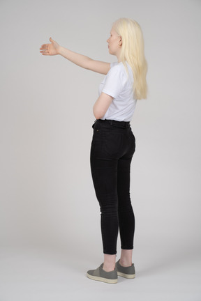 Back view of a blonde woman with her arm raised