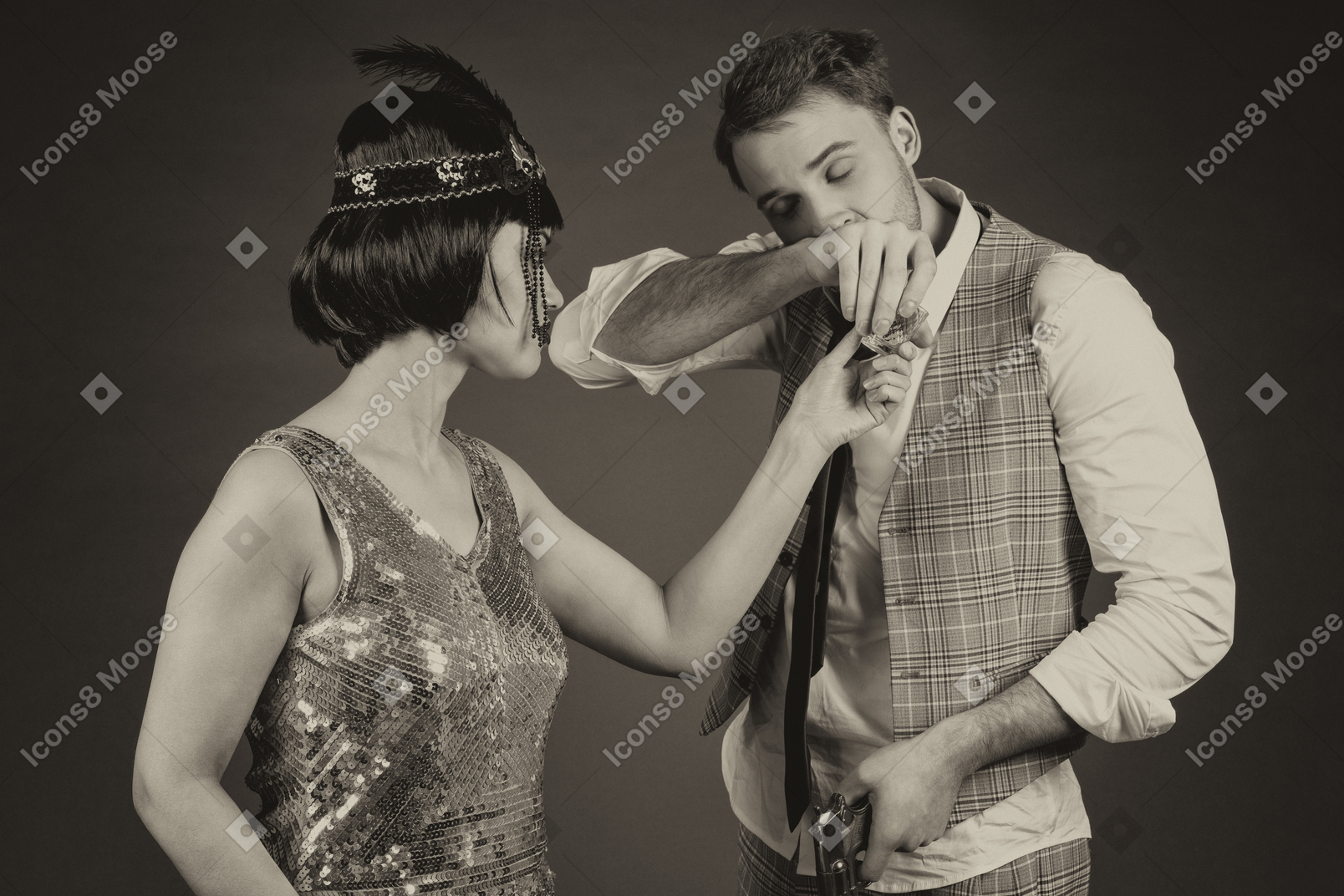 Stylish woman in headdress watching a young man sniffing drug