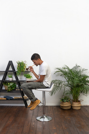 Good looking young man sitting on a chair