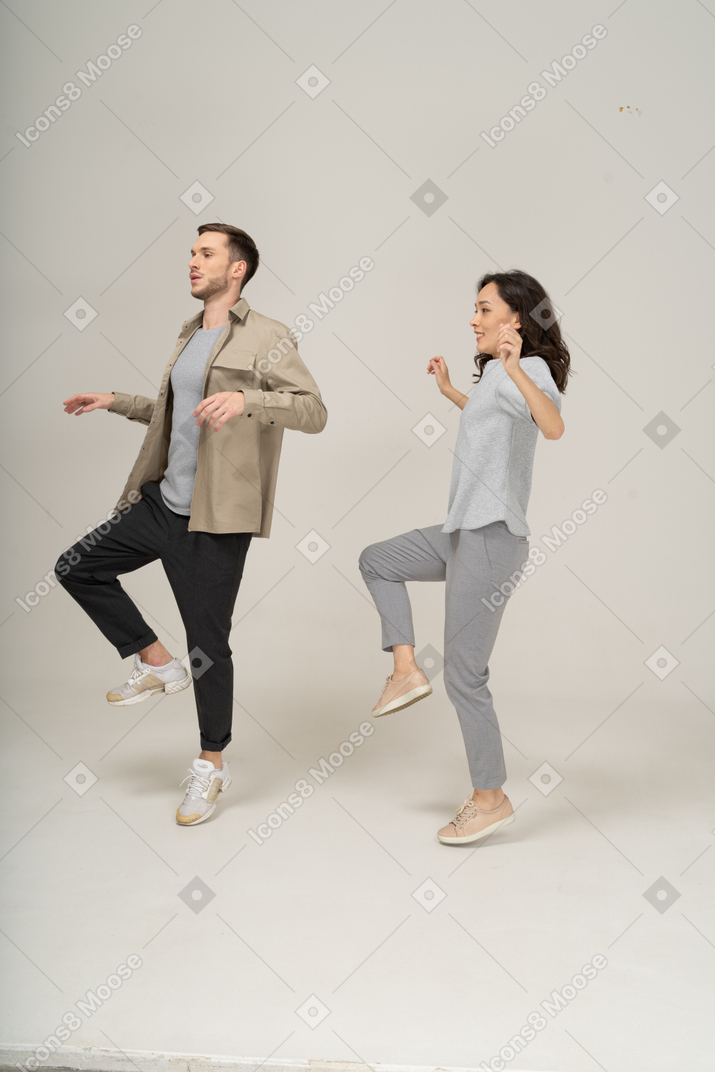 Two dancers raising their legs
