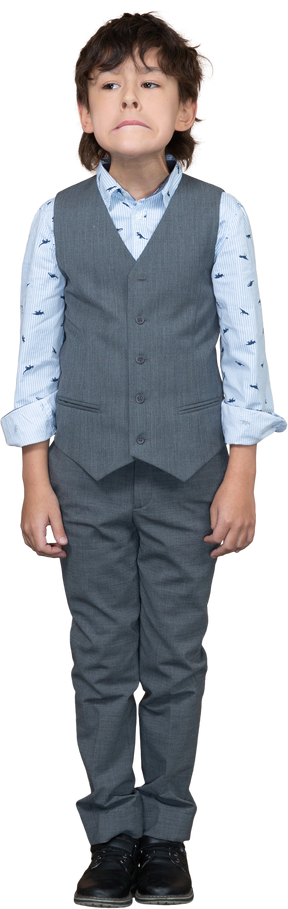 Front view of a boy in suit making faces