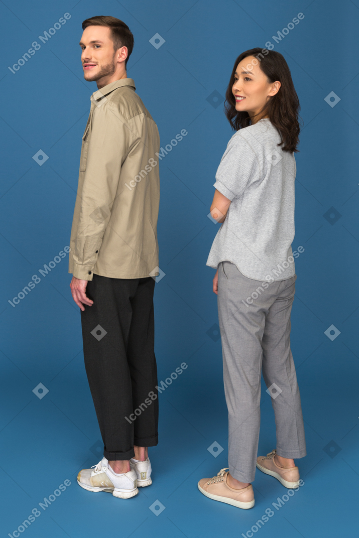 Homem sorridente e mulher olhando de soslaio