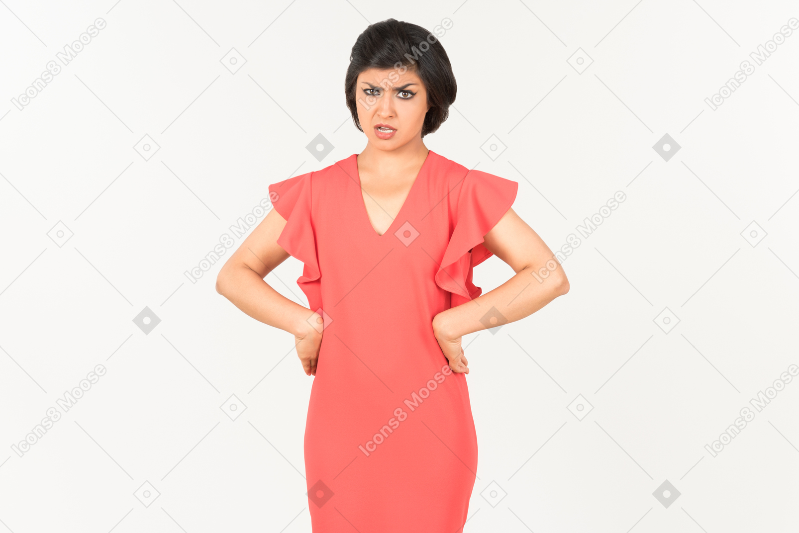Mad looking young indian woman standing with hands on hips