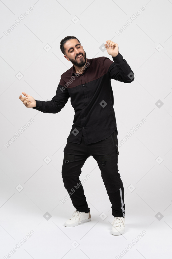 A cheerful young man dancing and gesturing