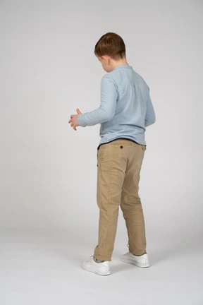 A young man in a blue shirt and khaki pants