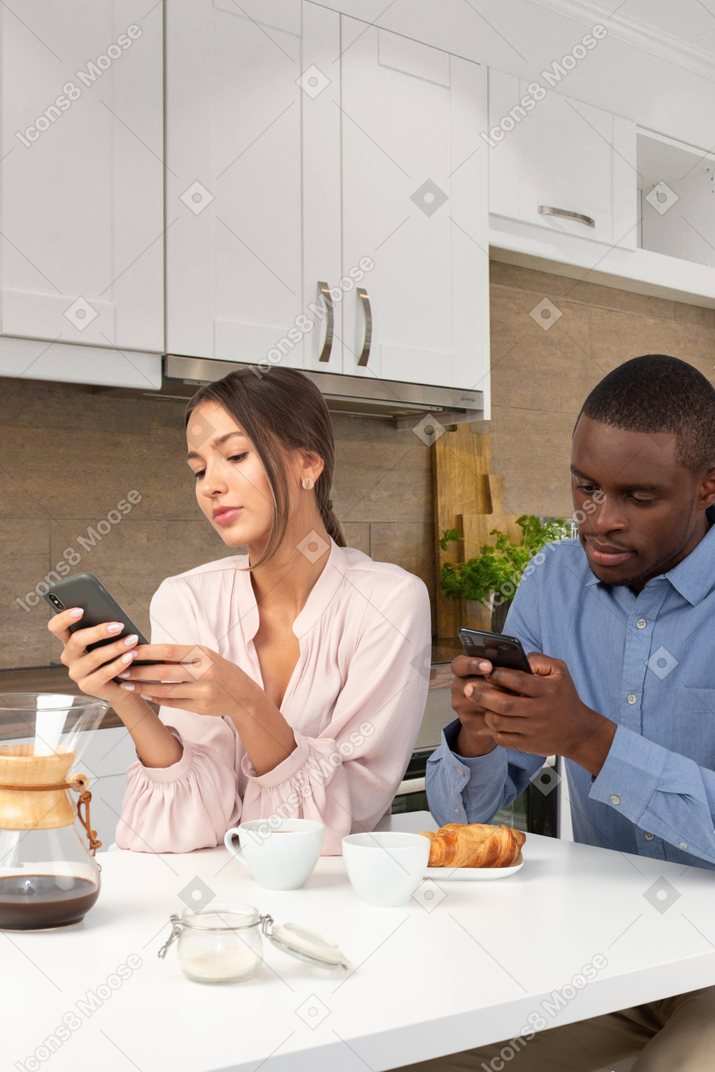 Man using a smart phone in the kitchen