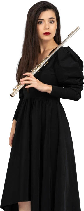 Three-quarter view of a serious young lady in black dress holding flute