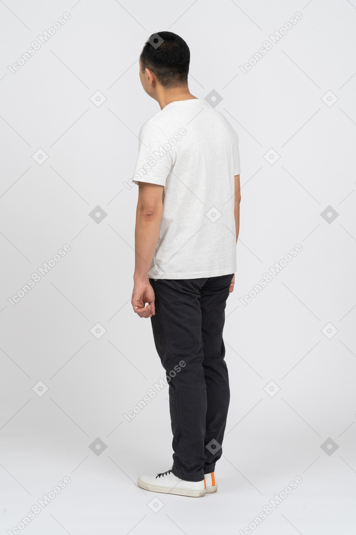Side view of a man in casual clothes looking up