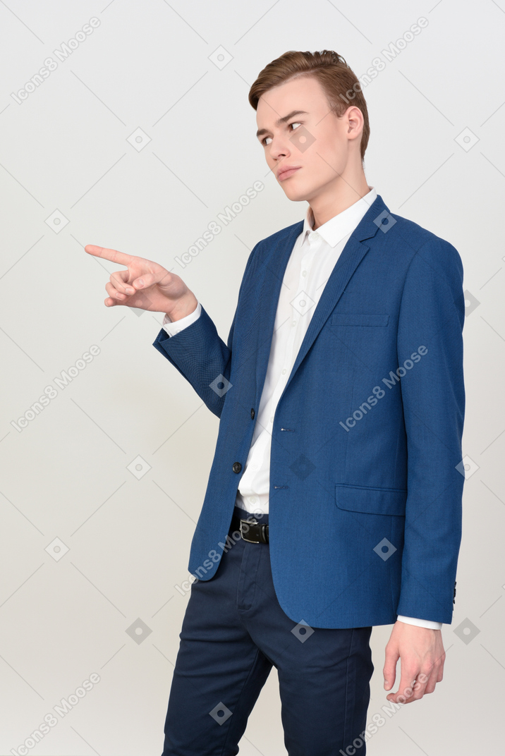 Handsome young guy pointing with a finger
