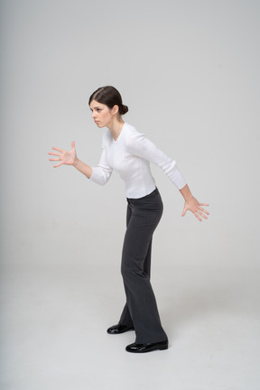 Side view of a woman in suit dancing