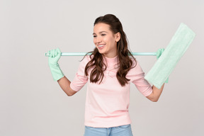 Attractive young woman holding a mop