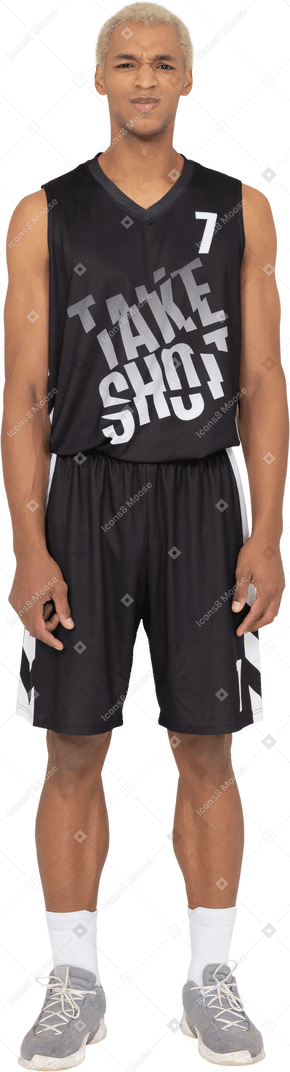 Front view of a displeased young male basketball player standing still
