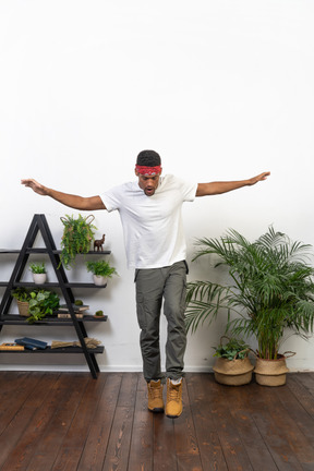 Good looking young man posing on the background of the apartment