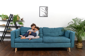 Good looking boy and girl play on the sofa