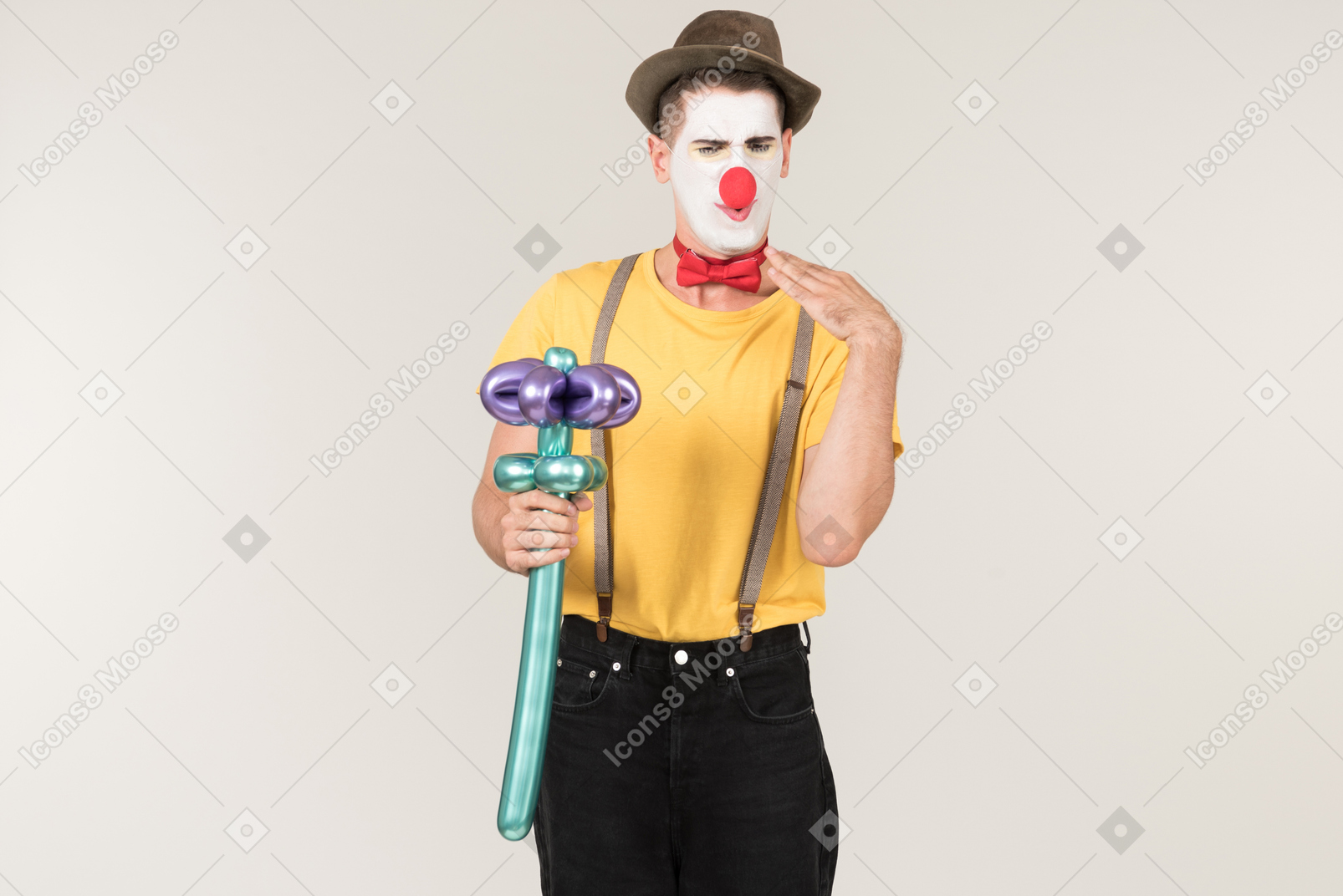 Disgusted with something male clown holding balloon flower