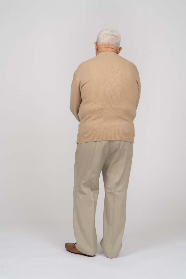 Rear view of an old man in casual clothes Photo