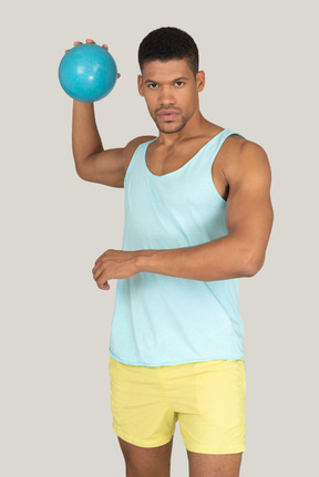 A man holding a blue ball in his right hand